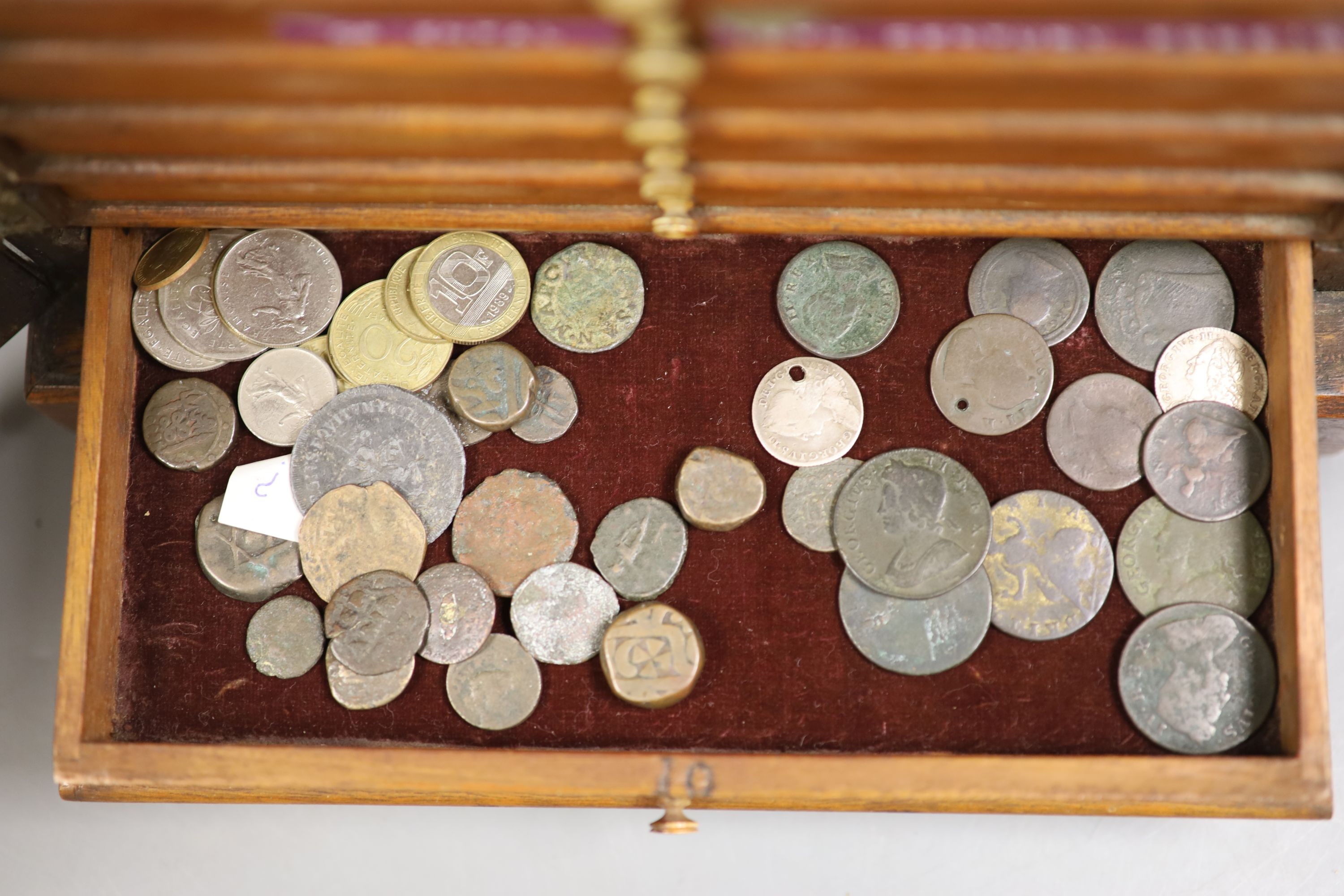 A mahogany coin collector's cabinet, fitted single door enclosing 10 drawers containing British and other coins (Georgian and later), tokens, etc.